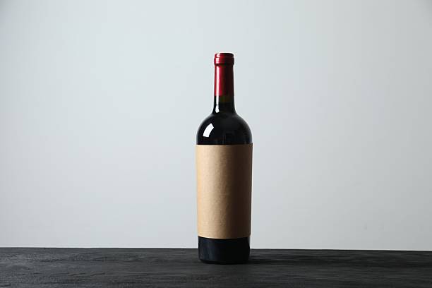 istock Bottle of red wine on wooden table 2253570895