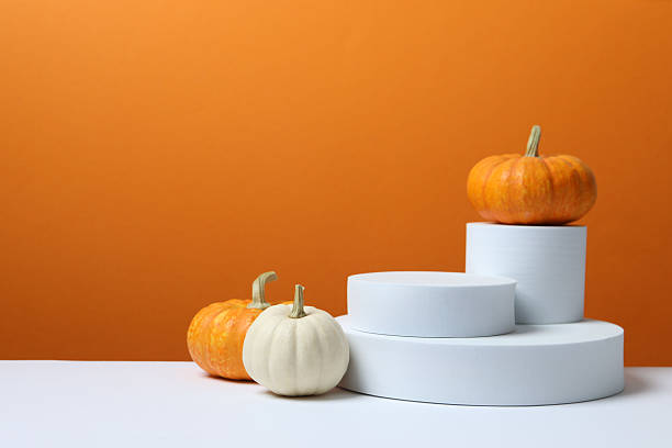 istock White podiums with pumpkin on two tone background 2253570904