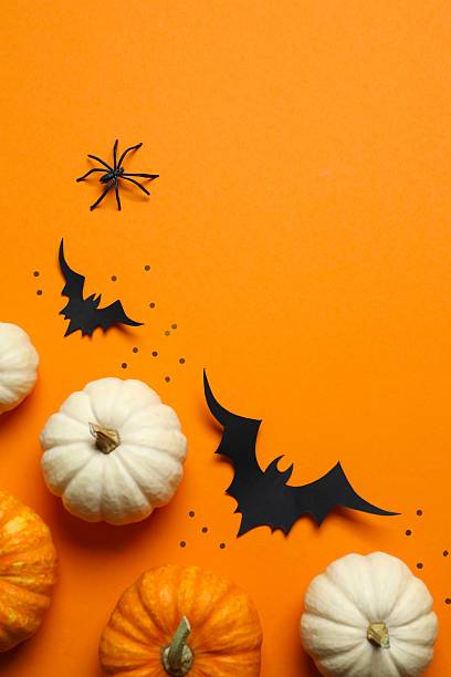 istock Halloween holiday decorations including pumpkins, spiders, bats on color background 2253570920