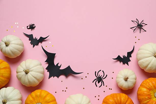 istock Halloween holiday decorations including pumpkins, spiders, bats on color background 2253570927