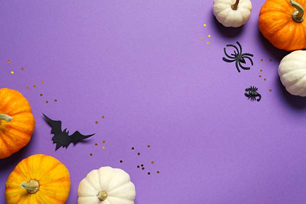 istock Halloween holiday decorations including pumpkins, spiders, bats on color background 2253570930