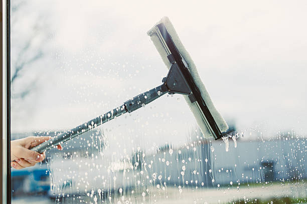 istock Professional Window Cleaning A Modern Technique with a Squeegee on a Bright Day 2253570956