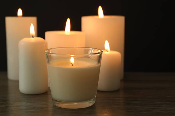 istock Burning candles in a dark space 2253571257