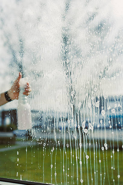 istock This closeup shot captures the process of window cleaning using a spray bottle under bright daylight, highlighting the streaks on the glass and the beautiful reflections of nature all around 2253572294
