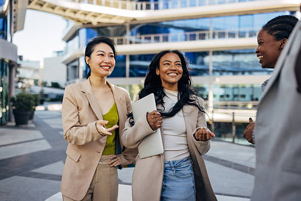 istock A multicultural group of businesspeople having a friendly conversation outdoors, set against the backdrop of sleek, modern office buildings in an urban area 2253572421