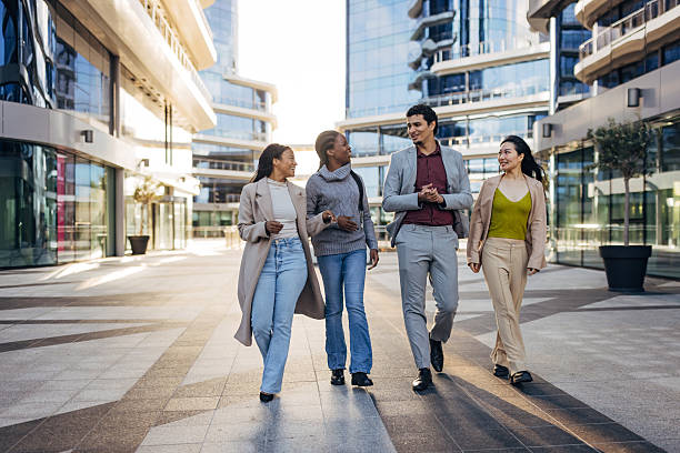 istock Multiracial group of business professionals walking together during a break, discussing work in front of a modern office building. Contemporary lifestyle and corporate teamwork concept 2253572682