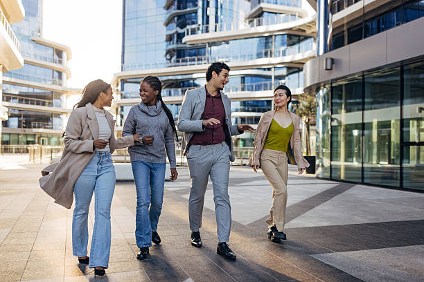 istock Multiracial colleagues in business attire sharing a conversation during a work break. Lifestyle business image set in a contemporary urban office environment 2253573752