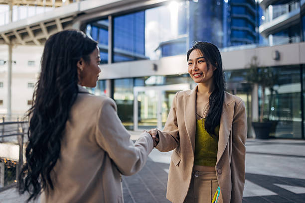 istock Multicultural professionals shaking hands outdoors after a meeting. Lifestyle business image illustrating partnership, inclusion, and professional relationships 2253574375