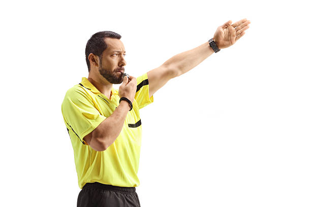 istock Football referee blowing a whistle and showing offside 2253575577