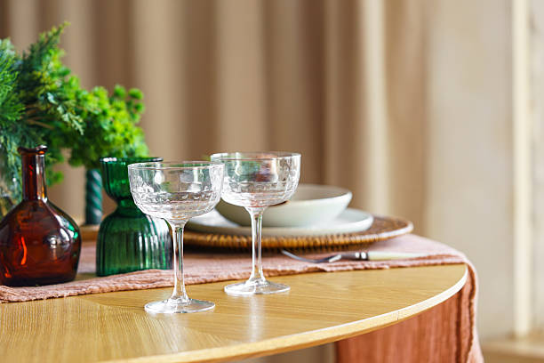 istock Elegant table setting with crystal glasses and plates with festive holiday or romantic decor 2253576092