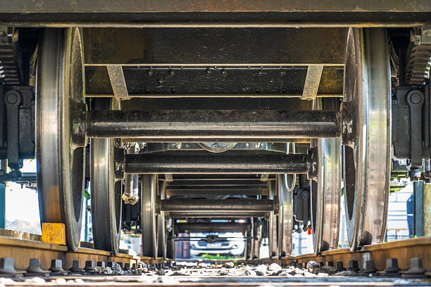 istock Green train car sits on tracks under bright sunlight in a rail yard, showcasing its vintage design and sturdy construction 2253576596