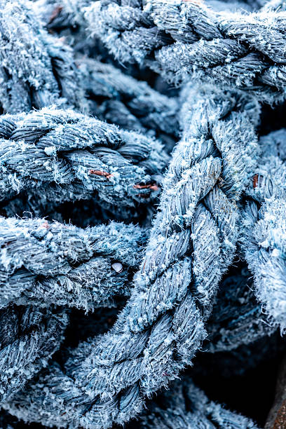 This intriguing image captures a tangled rope floating in the green-hued waters of Arrecife Harbor, Lanzarote. Partially submerged, the rope’s texture and details are clearly visible through the transparent water, creating a striking contrast between the man-made object and the natural aquatic environment. The interplay of light and shadow on the water’s surface enhances the depth and movement of the scene, evoking themes of maritime industry, coastal life, and environmental awareness.