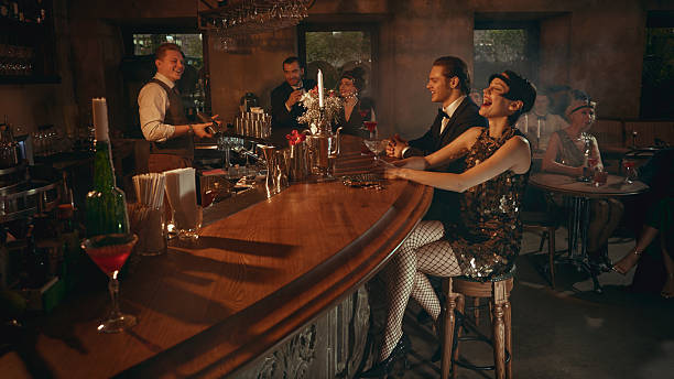 istock Vintage bar moment with laughing guests and bartender mixing drinks 2253577827