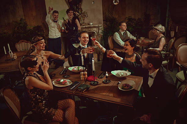 istock Stylish retro friends celebrating and toasting at festive dinner table setting 2253577859