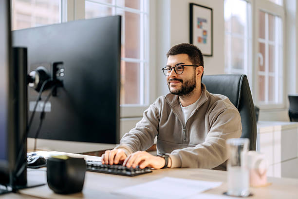 istock Casually clothed man working on a PC in the office 2253578142