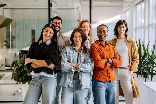 istock Group of coworkers posing for camera at the office 2253578402