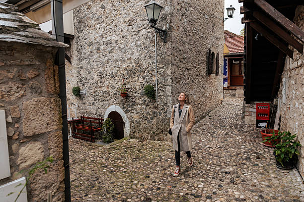 istock Woman Walking Through An Old Town Alley 2253579901