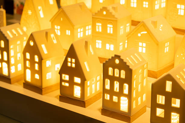 Glowing ceramic miniature houses with warm internal light.