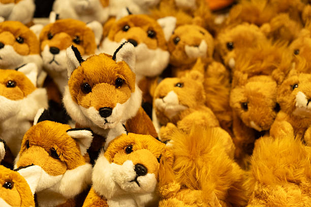 Close-up of assorted soft stuffed animals on a shop shelf.