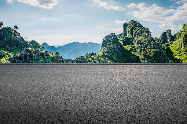 istock Empty asphalt road ground and beautiful green mountain range landscape under blue sky with clouds. 2253580572