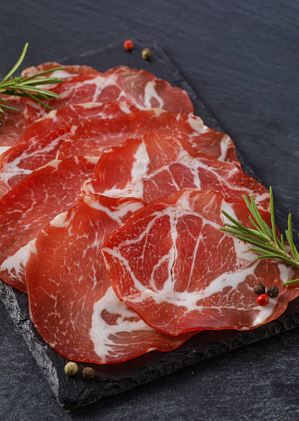 istock Sliced coppa cured meat with rosemary and black pepper 2253590914
