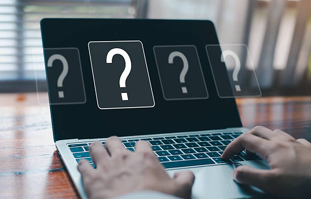 istock Person typing on laptop with virtual question mark icons on screen, representing online inquiry, problem solving, FAQ, customer support, information search, uncertainty and digital technology concept 2253592056