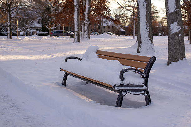 istock Snow covered bench in a quiet winter park 2253600247