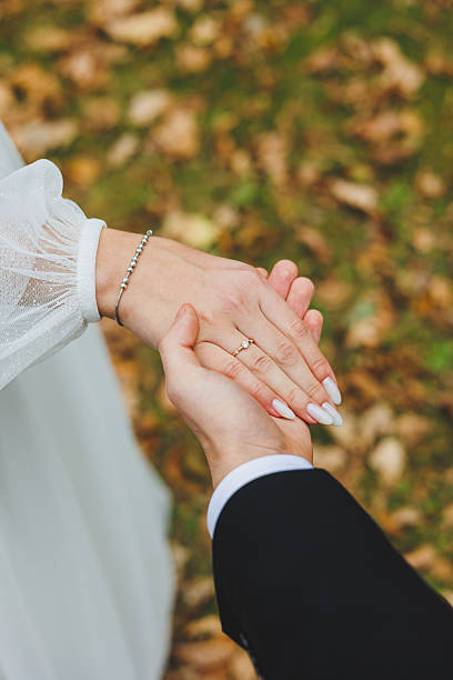 istock A Romantic Couples Hands Holding Each Other Warmly During Their Beautiful Autumn Wedding Ceremony 2253601057