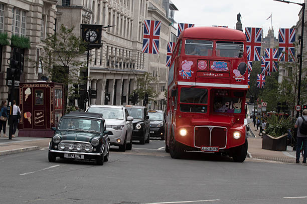 LONDON, UNITED KINGDOM - 4 AUGUSTUS , 2023: English union jack flag in central London with buses and other traffic.