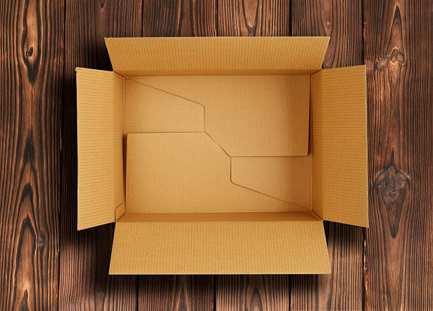 High quality opened rectangular blank empty cardboard brown box isolated on wooden background. Front view angle. Closeup studio shot for postal delivery and suitable for food, cosmetic or medical packaging.