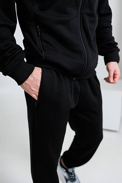 istock A man in a black jacket and pants has his hands in pockets 2253604254