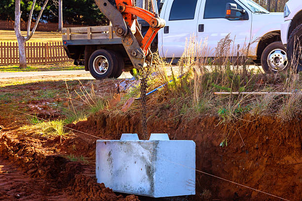 istock Heavy machinery sets concrete block in ground on construction site during at retaining walls 2253605464