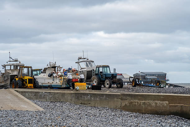 Cromer, Norfolk, UK - December 24 2025. Fishing boats and equipment on the beach in the seaside town of Cromer, North Norfolk coast