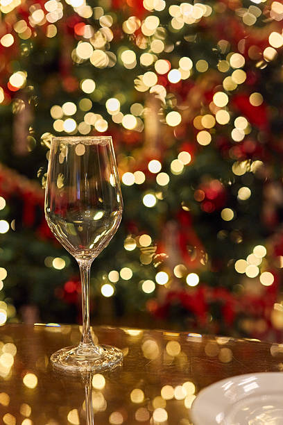 Empty Wine Glass Against Festive Bokeh, Polished Stemware On Reflective Tabletop, Soft Golden Lights