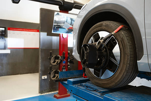 istock Car wheel alignment service using digital equipment in modern auto repair shop 2253612486