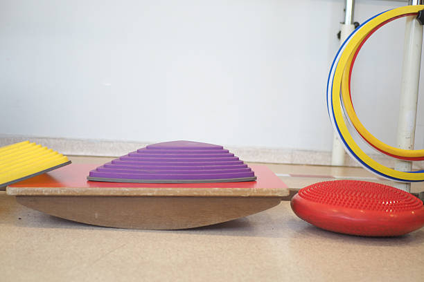 Balance training tools include colorful disks and boards indoors.