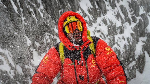 istock Climber in Red Jacket and Yellow Goggles on Snowy Mountain 2253612942