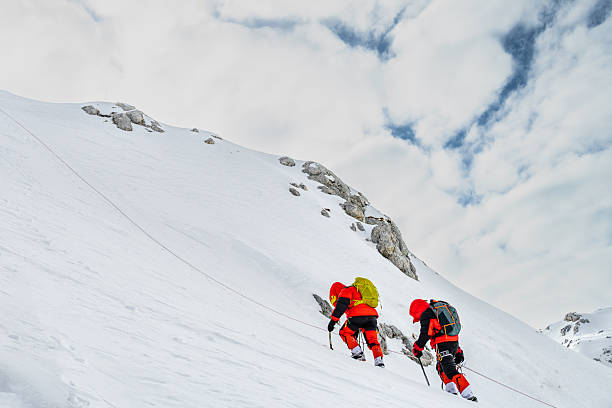 istock Climbers Ascending Snowy Mountain Slope, Tethered for Safety 2253612958