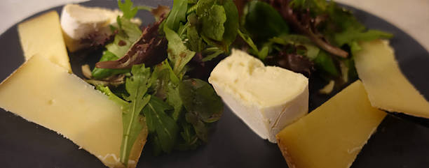 Cheese platter and assorted dressed green salads