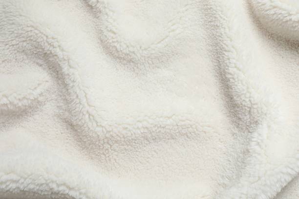 istock White cuddle teddy bear fabric as background, top view 2253614428