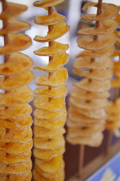istock Crispy spiral potato snacks being sold at a market 2253614464