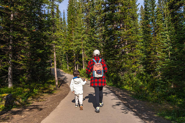 istock Mother and son walking on a path in banff national park 2253615457
