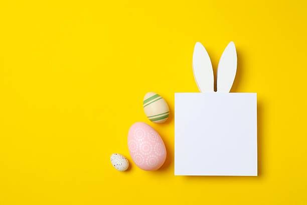 istock Happy Easter. Colorful eggs with bunny ears on color background, space for text or advertising 2253615521