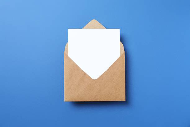 istock Craft envelope with white paper card on blue background 2253615745