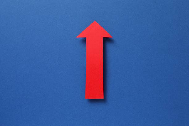 istock Paper arrow on color background, top view 2253615883