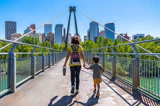 istock Mother and son walking on a bridge in calgary, canada 2253616109