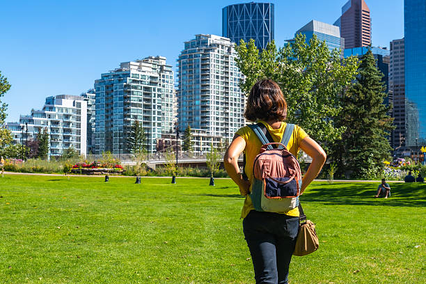 istock Tourist walking in a park with calgary skyline in background 2253616163