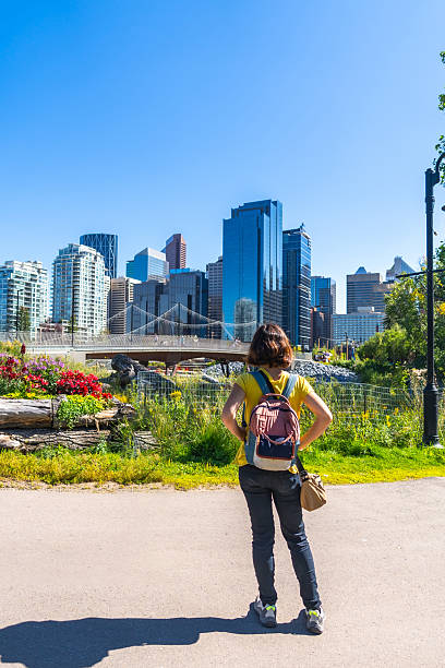 istock Tourist admiring calgary's skyline from st. Patrick's island park 2253616164