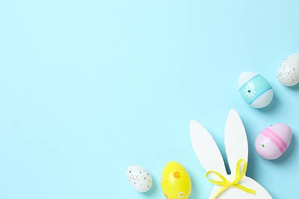 istock Happy Easter. Colorful eggs with bunny ears on color background, space for text or advertising 2253616323