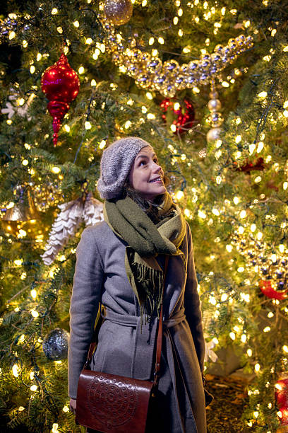 istock Woman standing under Christmas lights at night 2253616653